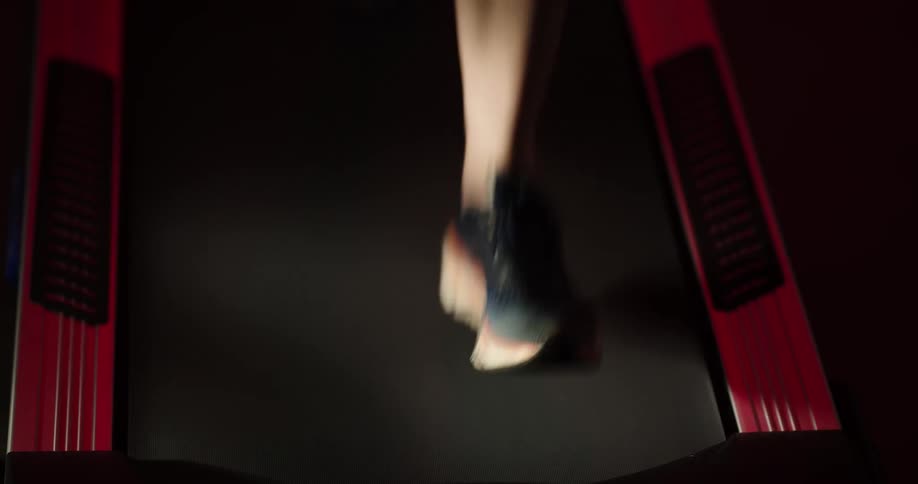 A person is running on a treadmill during the day time