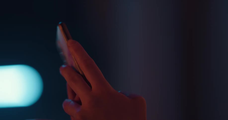 Close up of womans hands texting on smartphone in the gym