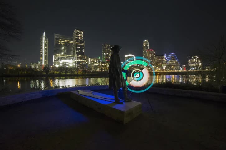 A light wheel spins next to the stevie ray vaughan memorial  statue in texas