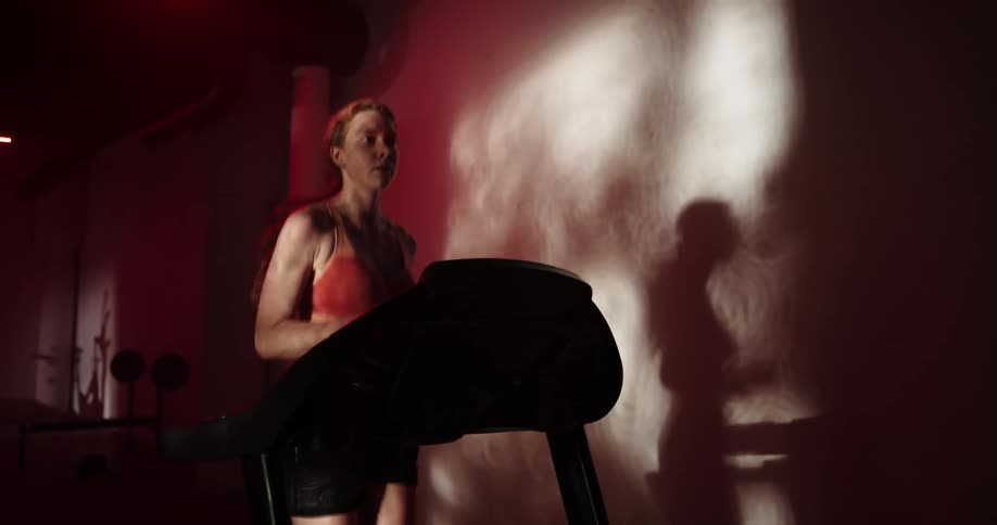 A woman is on a treadmill jogging