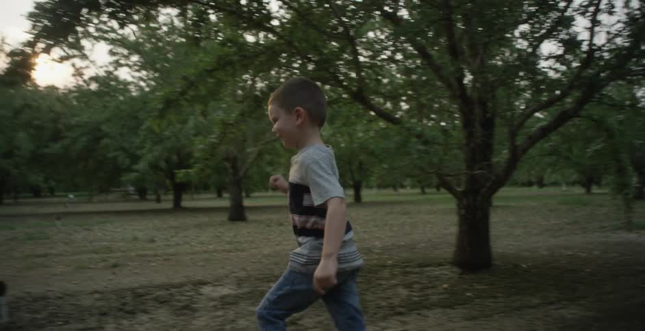 A child is running through the woods