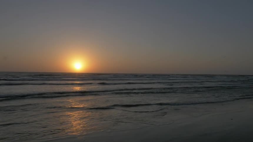 The sun is setting over this beach