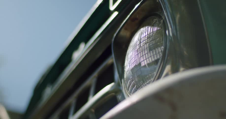 Close up view of a headlight on a car is displayed