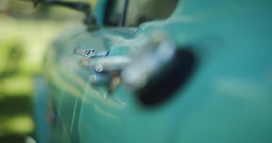 Close up view of a blue vehicle is displayed