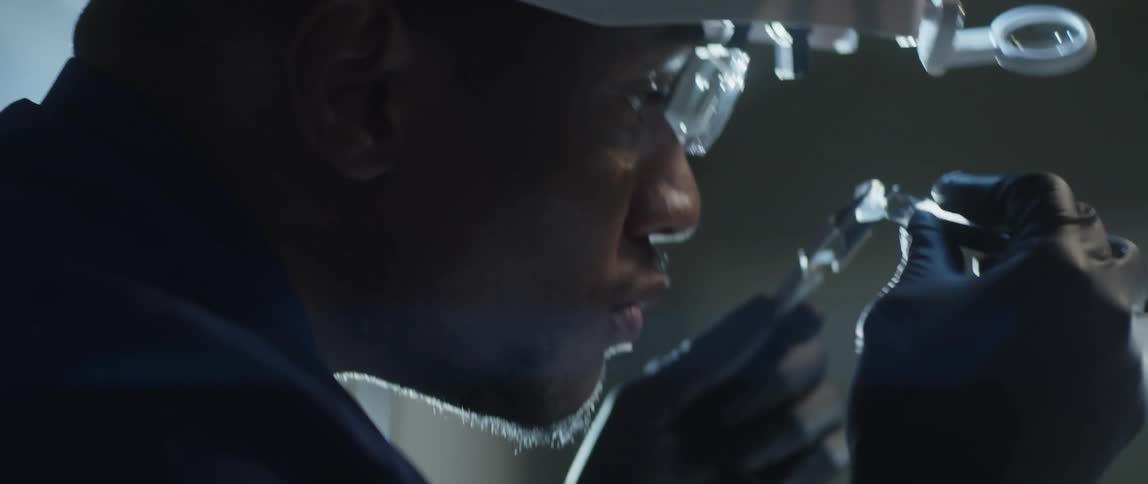 A person inspecting a crystal