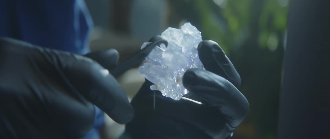 An employee working on a stone with a pick