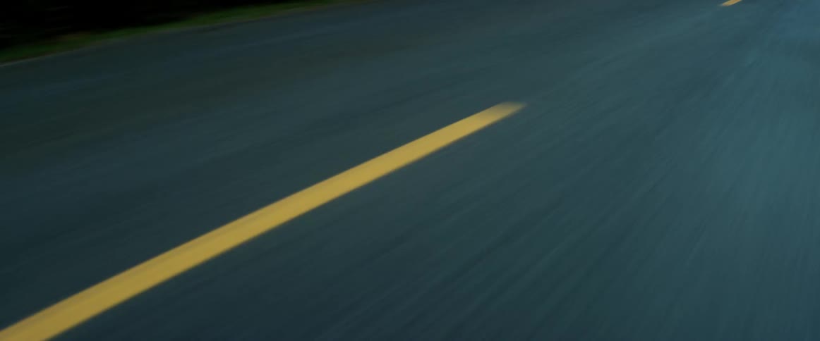 Yellow dash marks divide lanes on a road