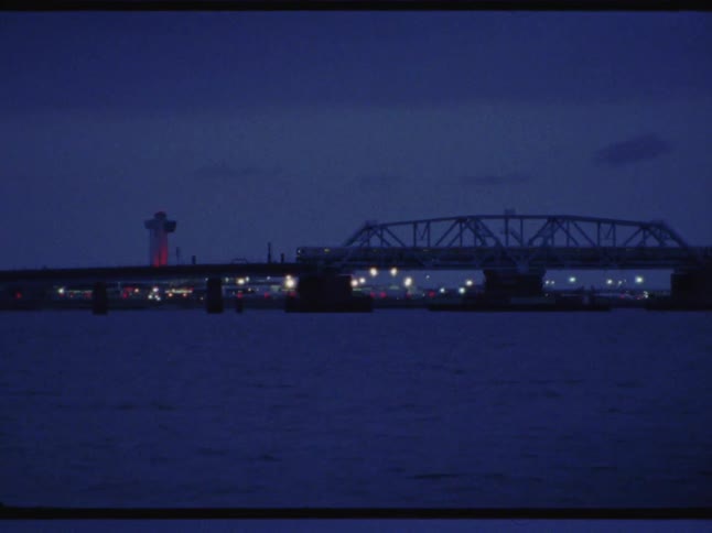 A train going across a bridge over water