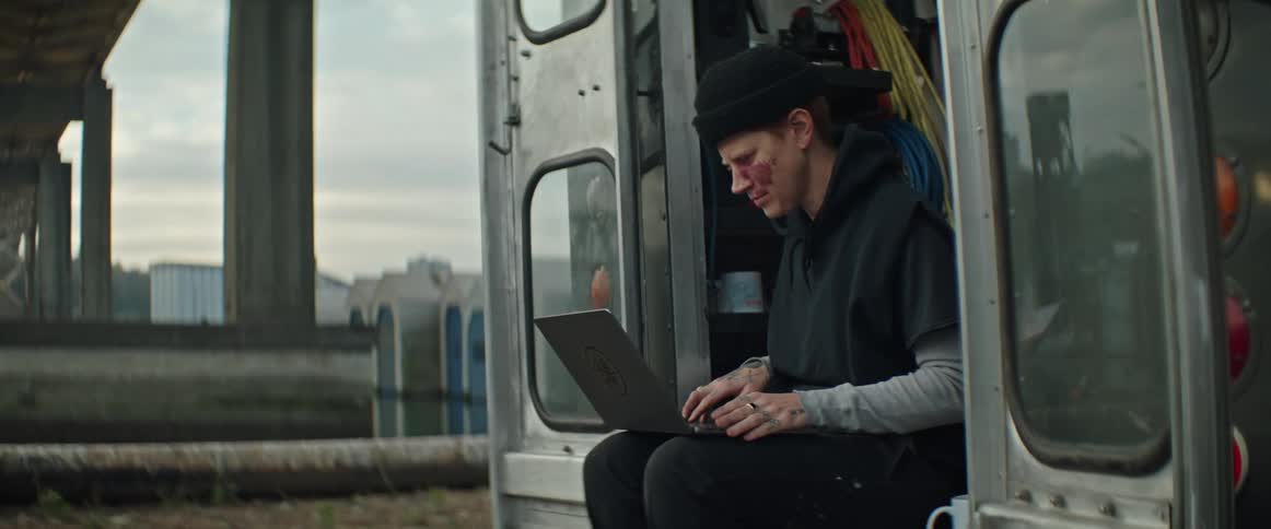 Closing shot of a person using a laptop on the back of a truck