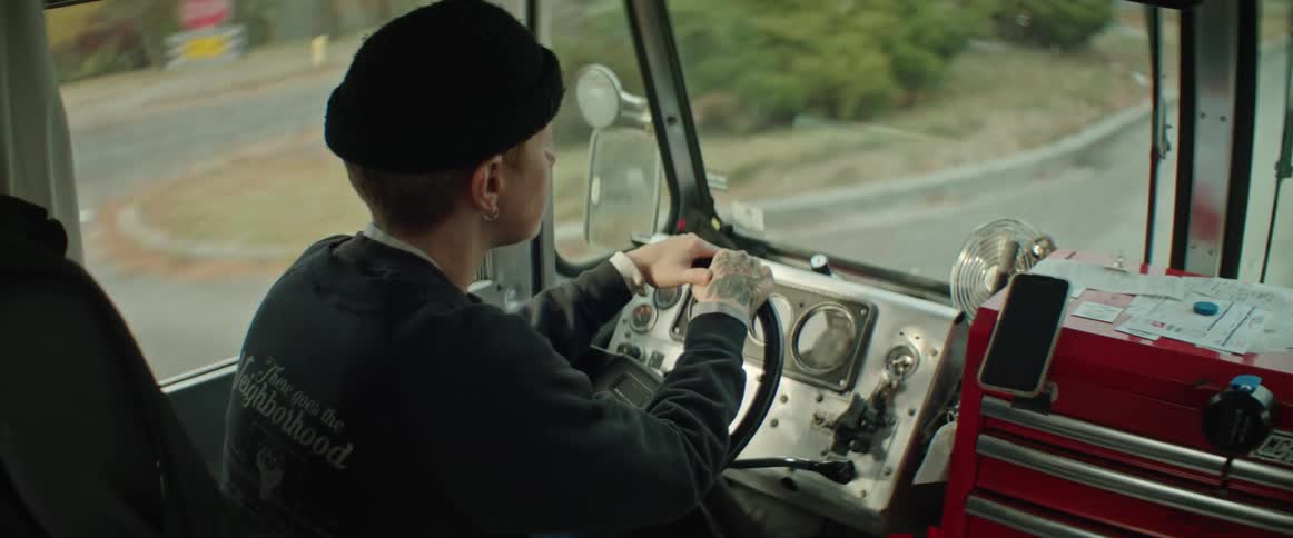 A woman is driving a large truck