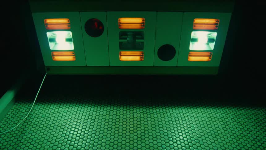 A red floor leading up to a machine with lights