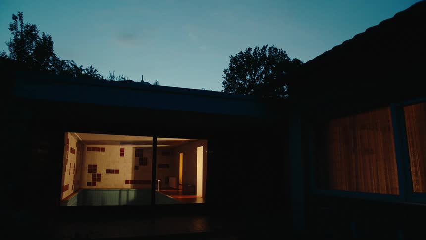 Lights glowing inside a silhouetted house at night