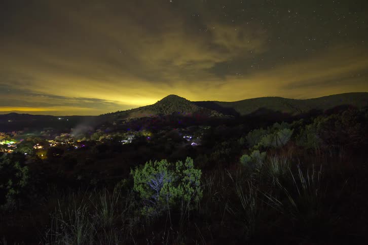 Lights flash over a mountain at night