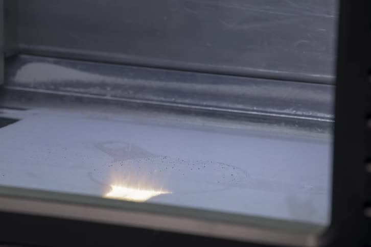 A machine is carving something with light