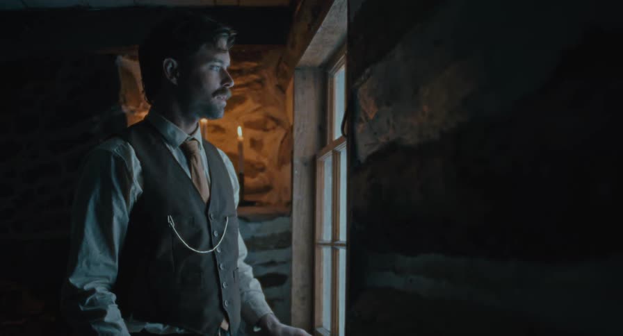 A man walks up to a window