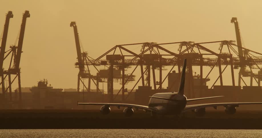 A passenger plane sits parked in an airfield