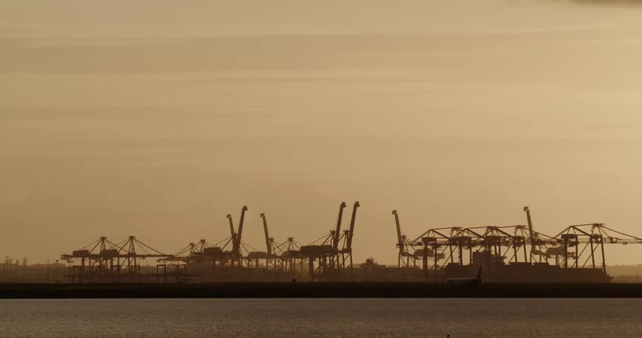 Panning shot of a cargo rig on a harbor