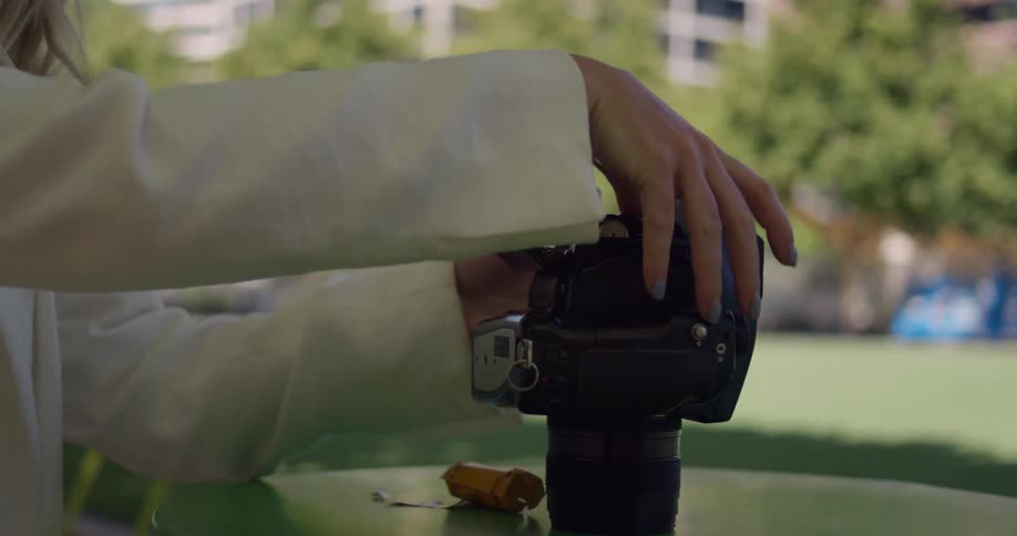 A woman loads film in to a camera