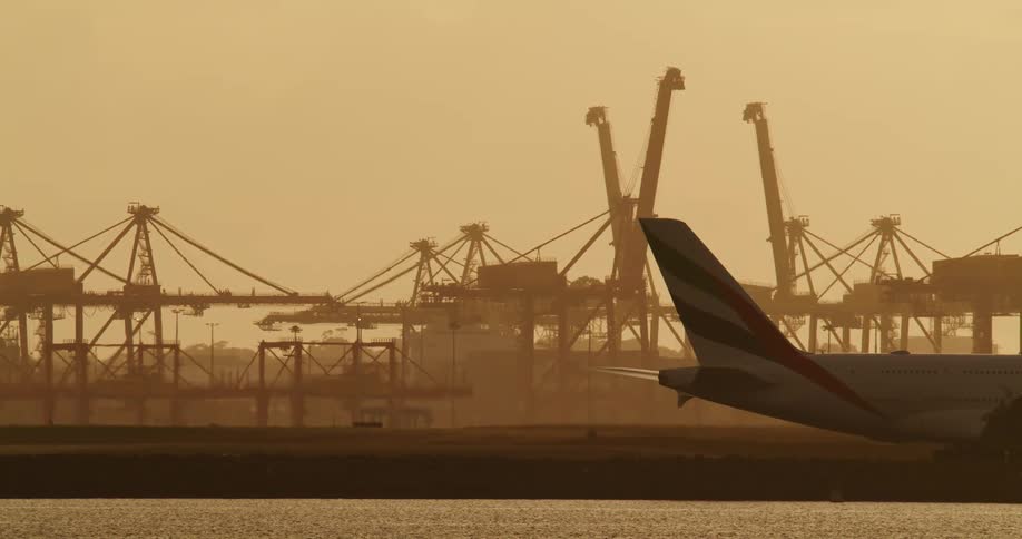 Heavy smog hovers over an airplane rolling past a construction area