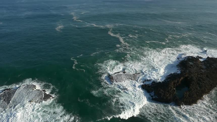 Waves crash over rocks in the ocean