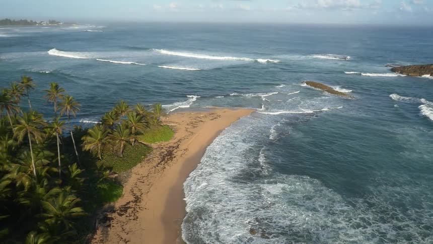 Waves roll onshore in a tropical area