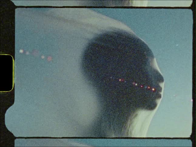The wind blows a veil of transparent material that is over the head of a man
