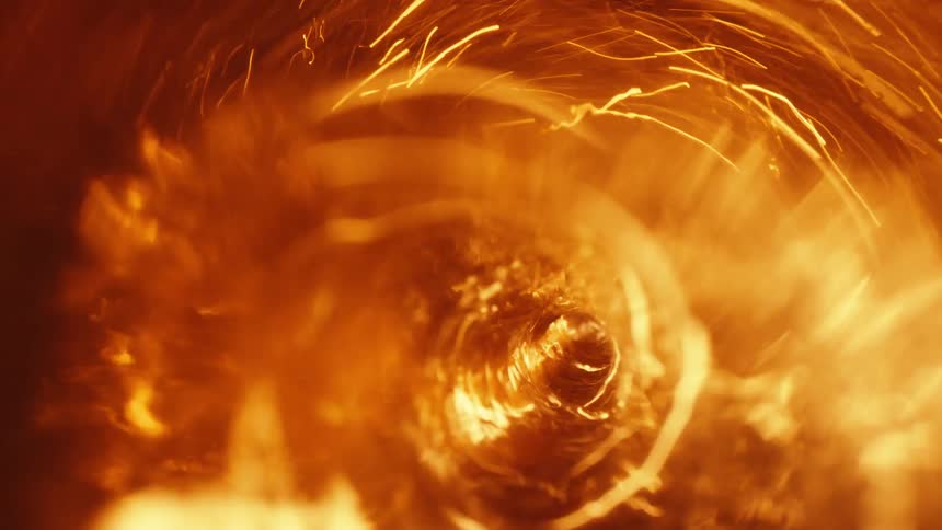 Light shines upon an orange whirlpool as yellow sparks spin wildly in the vortex