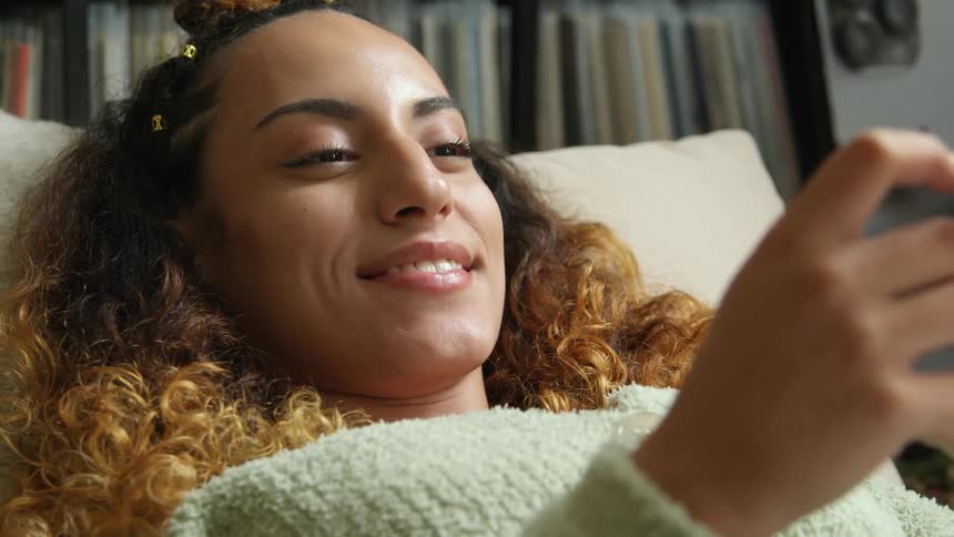 A woman using a smart phone in a room