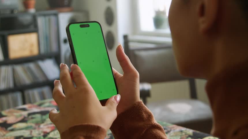A woman using a smartphone at home