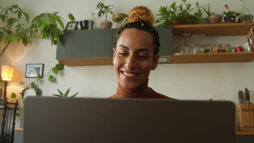 A woman using a laptop in a room