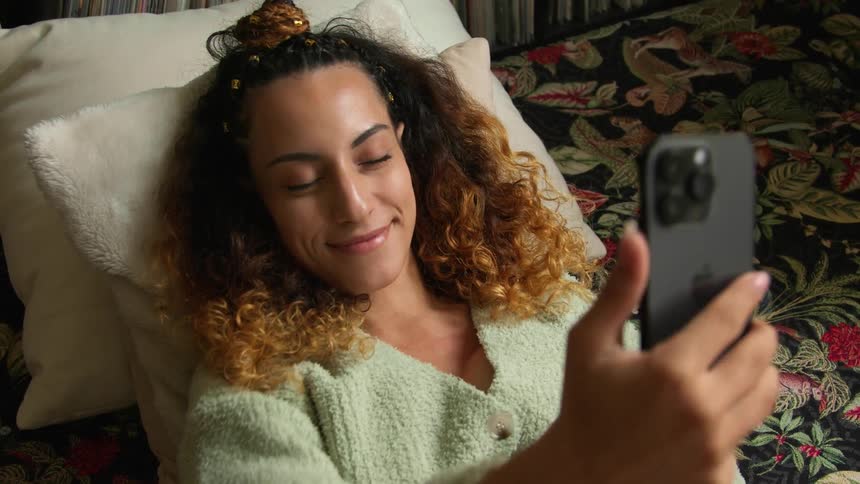 A woman using a smartphone to take a selfie