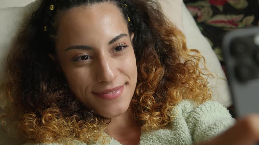 A woman takes a selfie with her smartphone