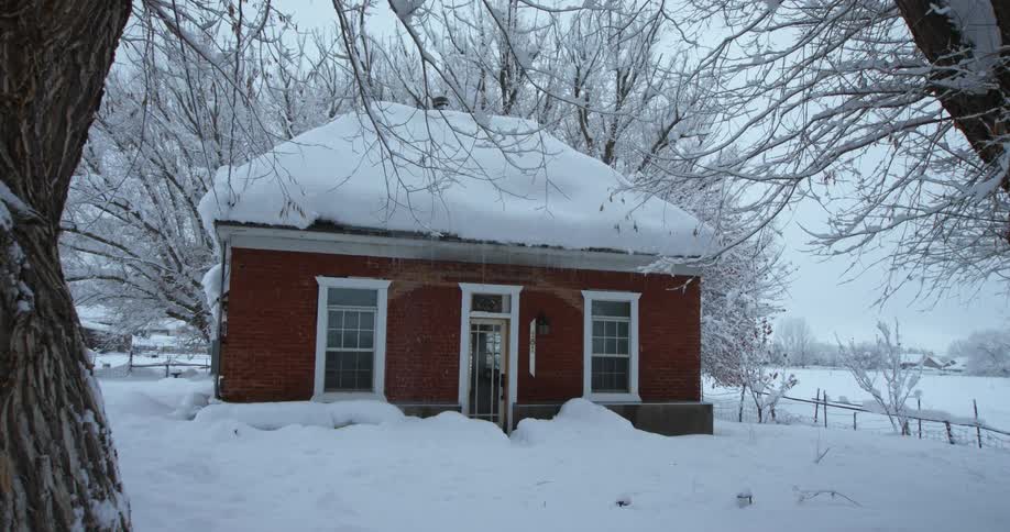 Its snowing in a rural area during winter season