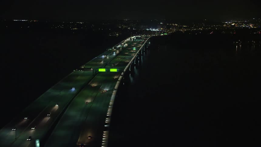 Light traffic is seen passing over the Woodrow Wilson Memorial Bridge over the Potomac River in Fort Washington Maryland during the night