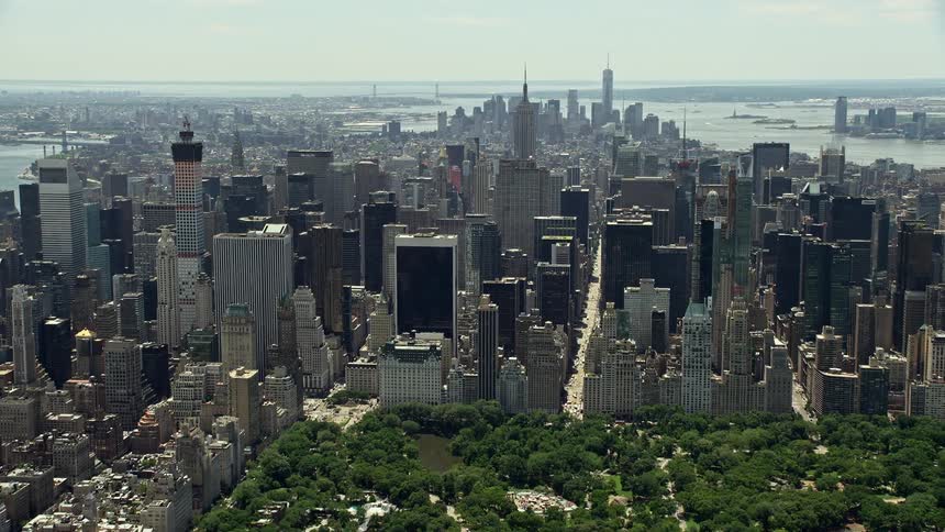 Aerial view of Lower and Midtown Manhattan skyscrapers from Central Park on a hazy day in New York City