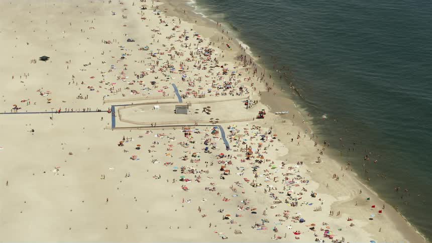 An aerial view of people having fun and enjoying the sunshine on Jones Beach State Park in New York
