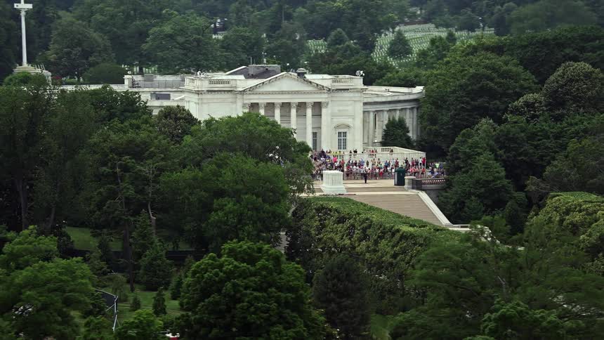 Aerial footage of tour groups paying their respects at the Tomb of the Unknown Soldier in the historic and spiritual Arlington National Cemetery Washington DC