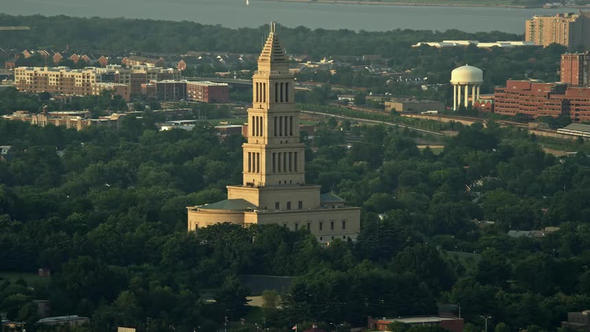 Aerial footage during sunset showing the George Washington Masonic National Memorial landmark in Alexandria Virginia
