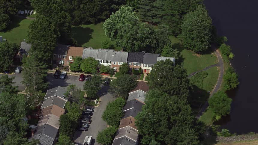 A birds eye view of residential row houses near the waterfront in Burke VA during a sunny day