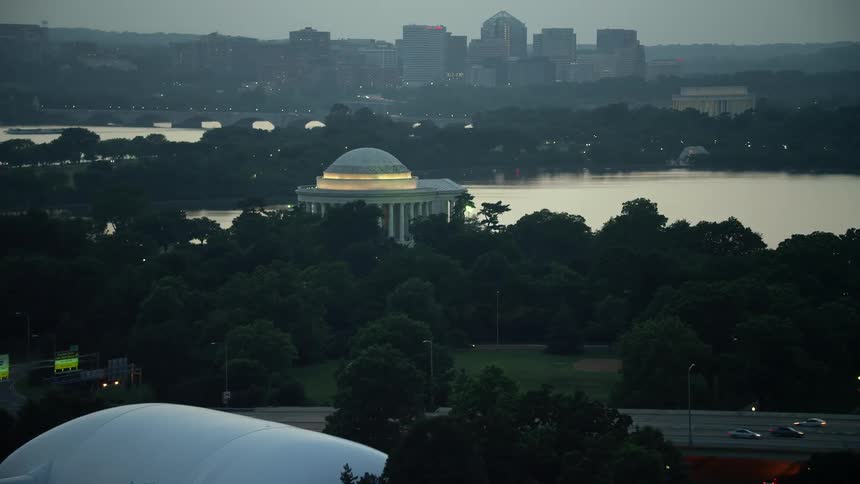 Approaching the iconic Jefferson Memorial at twilight aerial footage showcases the historical landmark beside Tidal Basin in Washington DC