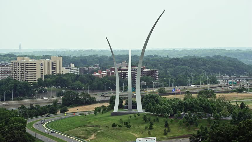 Approaching United States Air Force Memorial at Arlington National Cemetery in Washington DC during daytime aerials of Arlington Virginia
