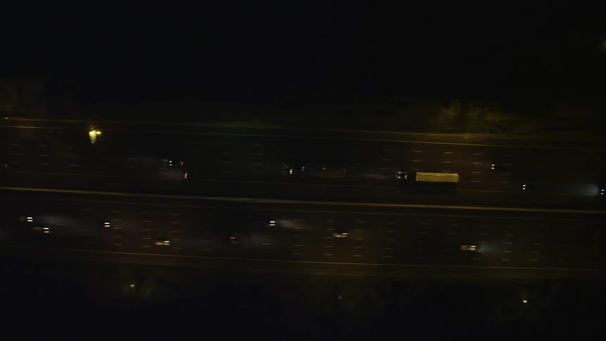 A birds eye view of light traffic on Interstate 95 at night in Alexandria Virginia captured in aerial footage