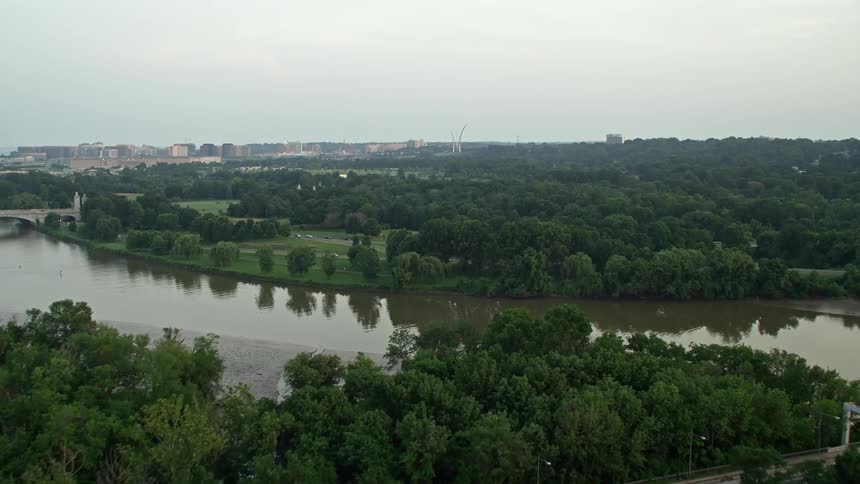 Aerial footage captures the beautiful sunset view of Lady Bird Johnson Park and Arlington National Cemetery in Washington DC