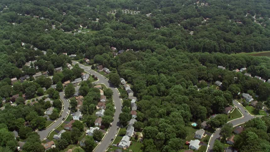 Aerial view of suburban homes and trees in Fairfax Virginia on a sunny day