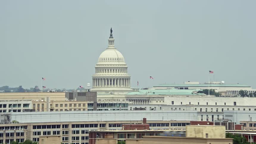 An aerial view of the United States Capitol dome towering above office buildings in Washington DC