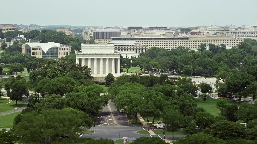 An aerial view of the Lincoln Memorial and surrounding green trees during summer in Washington DC