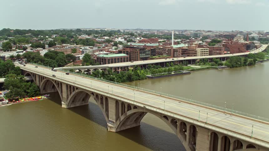 Aerial footage tracking light traffic on the Francis Scott Key Bridge in Washington DC during a partly cloudy day
