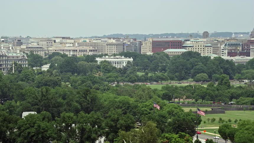 Aerial footage of The White House and surrounding buildings across the National Mall in Washington DC during summer