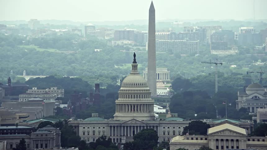 A breathtaking aerial view of United States Capitol and Supreme Court capturing the National Mall Monuments and other famous landmarks in Washington DC during the daytime
