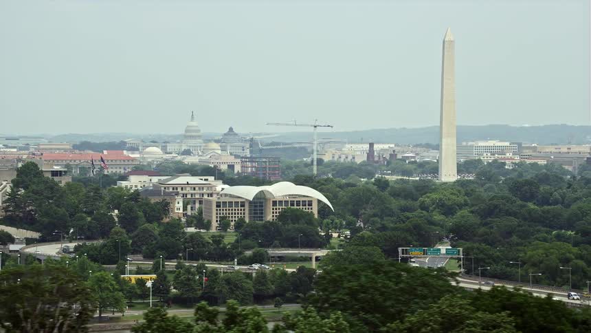 Aerial footage of the United States Capitol United States Institute of Peace and the Washington Monument in Washington DC showcasing its historical landmarks and iconic structures during daytime